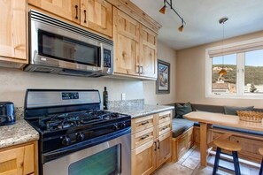 View of the fully-equipped kitchen and dining area