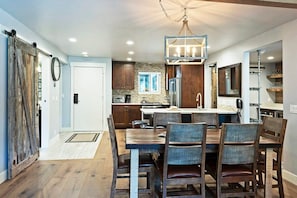A dynamic dining area with seating for six bridges the kitchen and living areas. Pull up  a chair and tuck into a favorite meal or pull out a board game while staying in the center of the fun.