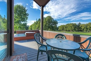 Private outdoor patio with lounge seating, and a deluxe hot tub