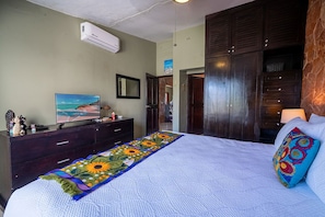 Master suite with king bed, TV and en suite bathroom