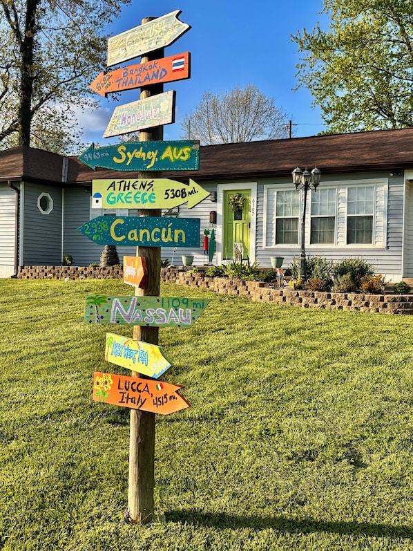 Front of house with fun directional sign