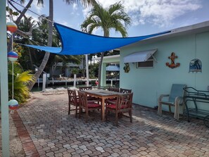 North Patio - Teak Dining Set, Shade Sail, Edison Lights (1 of 3 patio areas)