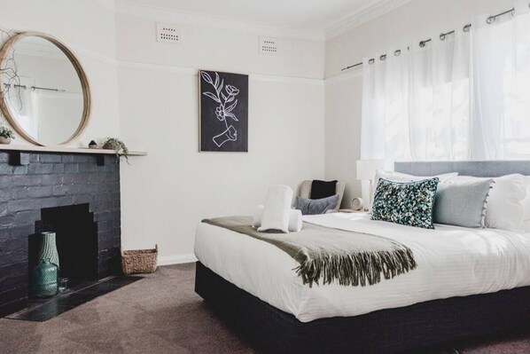 The primary bedroom offers black-out blinds, a ceiling fan and an open wardrobe for your belongings.
