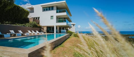 View of the Villa from the Pool Area - Shaded Sitting Area with outdoor kitchen