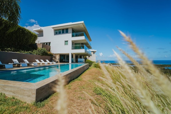 View of the Villa from the Pool Area - Shaded Sitting Area with outdoor kitchen