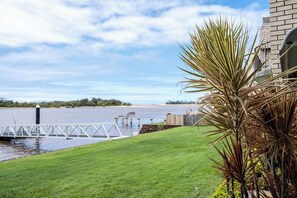 View of the grassed area and river from the patio.