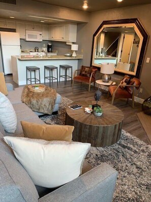 View of the family room, and fully-equipped kitchen with bar stool seating