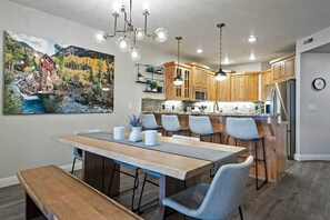 The stylish dining room features a table with seating for six conveniently located next to the kitchen where you will find a kitchen bar with additional seating for four.