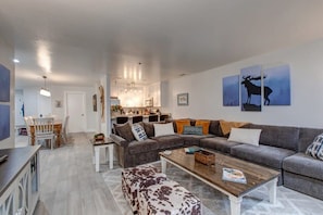 View of the family room, fully-equipped kitchen, and dining area