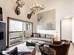 In addition to its welcoming layout, cozy furnishings and sophisticated design, this living space also opens up to a patio space featuring beautiful aspen views, and seating for two.