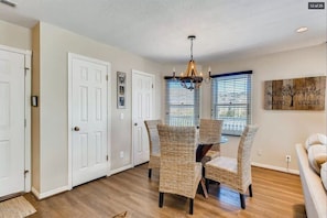 A refined dining area near the living area is an ideal place to enjoy a delicious meal or set up your favorite board game with seating for four.