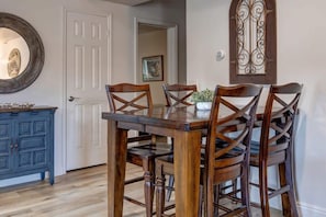 The dining area with seating for four is conveniently located off of both the living and kitchen areas and is an ideal space for digging into a delicious meal or setting up a favorite board game.