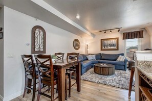 The dining area with seating for four is conveniently located off of both the living and kitchen areas and is an ideal space for digging into a delicious meal or setting up a favorite board game.