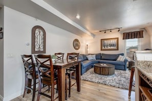 The dining area with seating for four is conveniently located off of both the living and kitchen areas and is an ideal space for digging into a delicious meal or setting up a favorite board game.