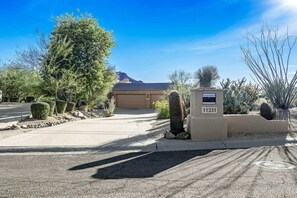 Ample driveway leads to three car garage