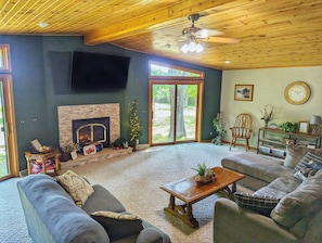 Open living room with cozy fireplace and large smart tv.