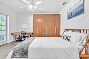 Queen bedroom with dedicated workspace & plenty of storage options.