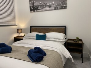 This comfortable room offers a comfortable bed with soft linens and warm lighting, creating a peaceful atmosphere. 
