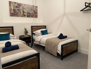 Spacious bedrooms with two double beds and each with a comfy bedding. Perfect for families or friends, offering a peaceful retreat with soft linens and cozy decor. Ideal for a restful night’s sleep after a day of exploring or work.