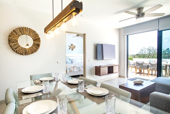 Dining/living with master bedroom and access to 1st floor terrace.
