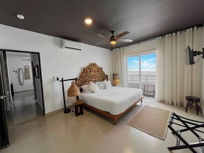 Experience a stunning king-size bed with a hand-carved Michoacan headboard.