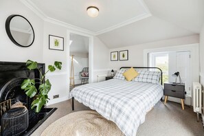 The double bedroom has the original Victorian cast iron fireplace and shutters