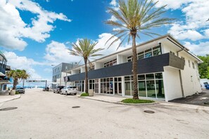 Sunshine state of mind: This vibrant building basks in the warm glow of the Florida sun, its glass windows reflecting the palm trees that line the street.
