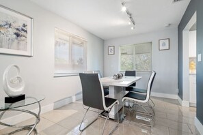 A dining room with a minimalist table and chairs. The perfect place to enjoy a simple and elegant meal.