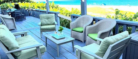 Beach side porch, heaven
lots of seating and a dining table