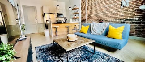 Experience comfort & style in this cozy living room inside the historic Mercantile building on Morris Ave. Fully equipped kitchen, modern decor, and access to amenities. Explore vibrant shops & restaurants nearby. Your perfect stay in Birmingham awaits!
