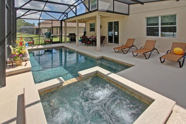 Screened back yard with Heated Pool and Spa