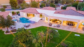 Birds eye view of this gorgeous open backyard w/ pool, games, & grass