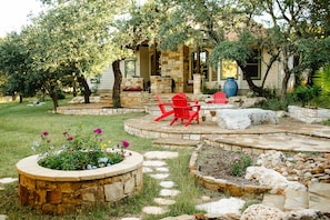 View of back yard with plenty of seating and firepit. 