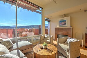 Living area with gas fireplace and mountain views