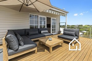 Upper deck lounge area with cantilever umbrella for shade