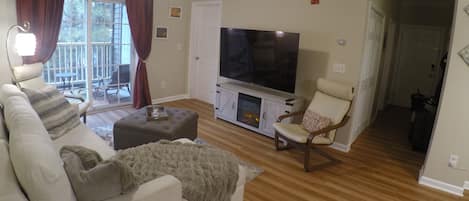 Relax with large screen TV, comfy chairs and throw blankets (extra in ottoman) leading out to private screened patio with lounge chairs