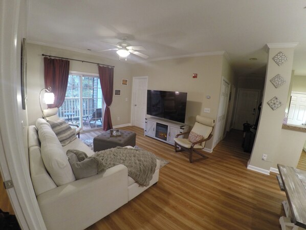 Relax with large screen TV, comfy chairs and throw blankets (extra in ottoman) leading out to private screened patio with lounge chairs