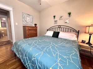 King bedroom with closet and dresser.