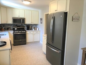 Beautiful kitchen with gas cooking and stainless appliances