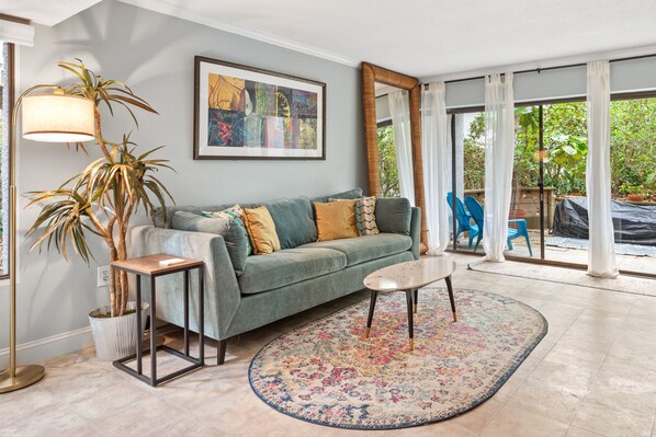 Living room with queen pull out bed and access to expansive private deck.