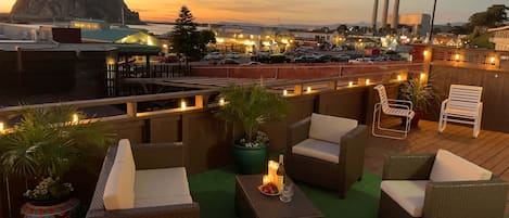 Private deck offers a panoramic view of  sunset, Morro Rock and Embarcadero St.