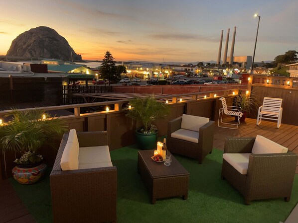 Private deck offers a panoramic view of  sunset, Morro Rock and Embarcadero St.