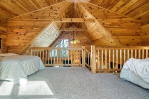 Charming upper-level loft furnished with a queen-sized bed and a double bed