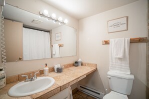 Downstairs hall bathroom with bath tub