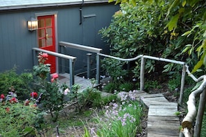 Repurposed driftwood forms the railing to the entrance.