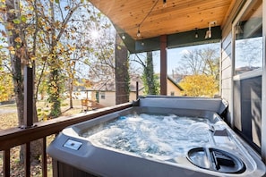 Private Hot Tub for 4 on the deck, looking out toward the lake.