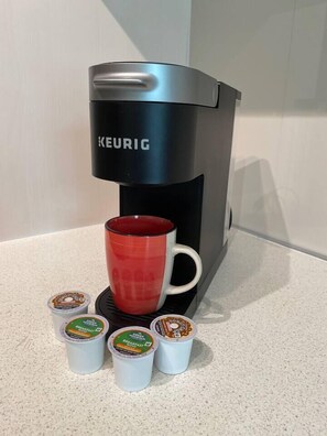 Keurig coffee maker.  We provide four coffee pods (two caffeinated, two decaf).  You can get more at Publix (full size grocery store) just two blocks away. 