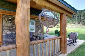 Elk Creek Retreat outside porch with logs.