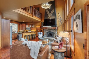 Main level living room with cozy wood fireplace