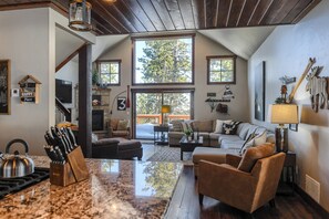 Main floor living room with large windows to take in the amazing scenery